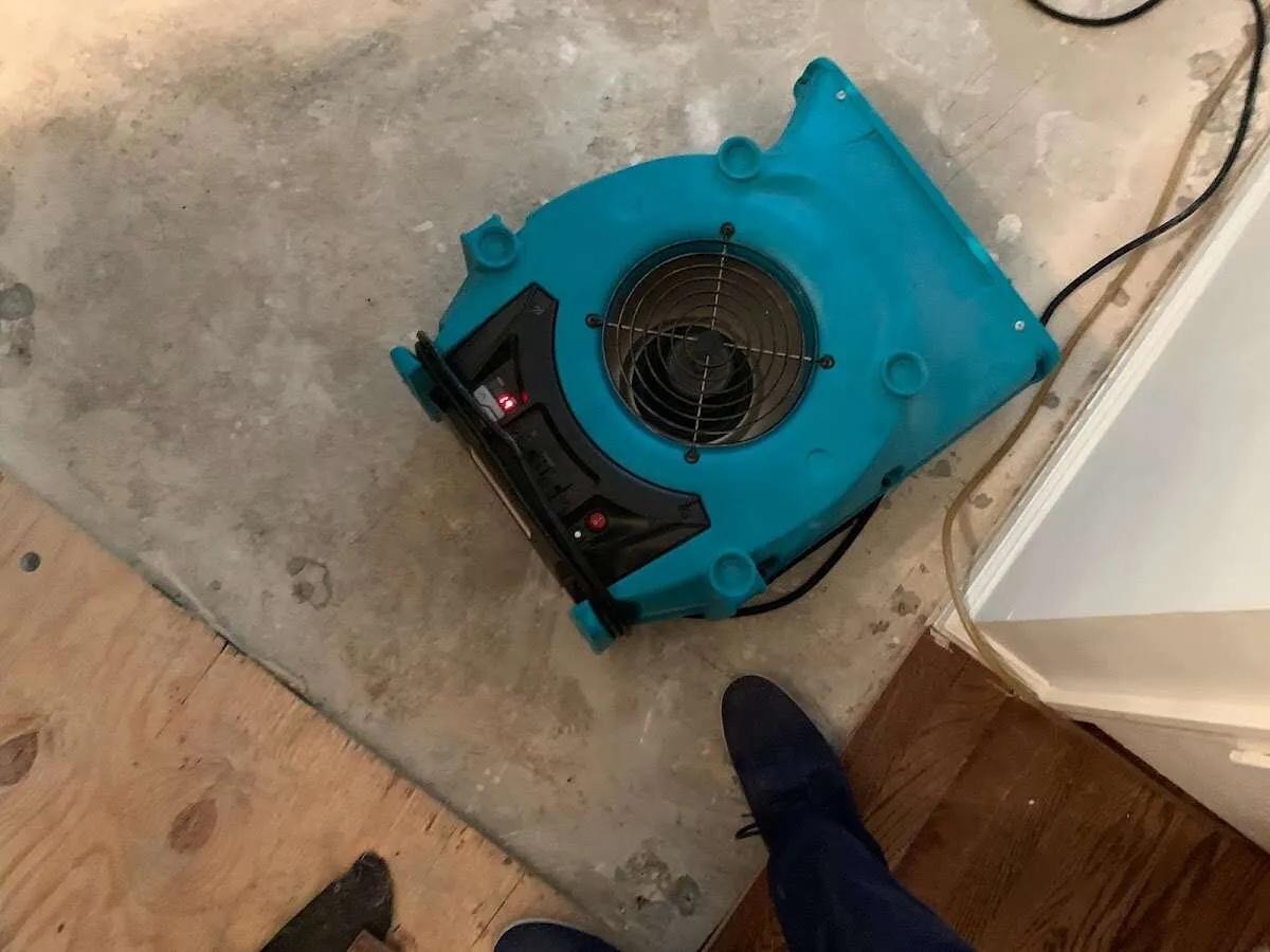 Air mover drying subfloor during Leak Detection & Repair in Chartiers